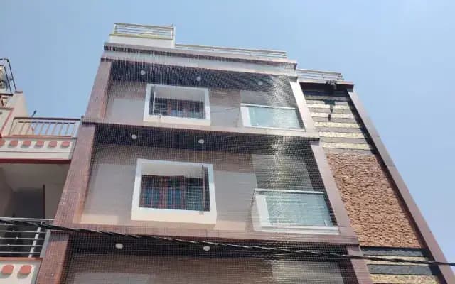 Exterior netting fitted across the front of a multi-storey residential building
