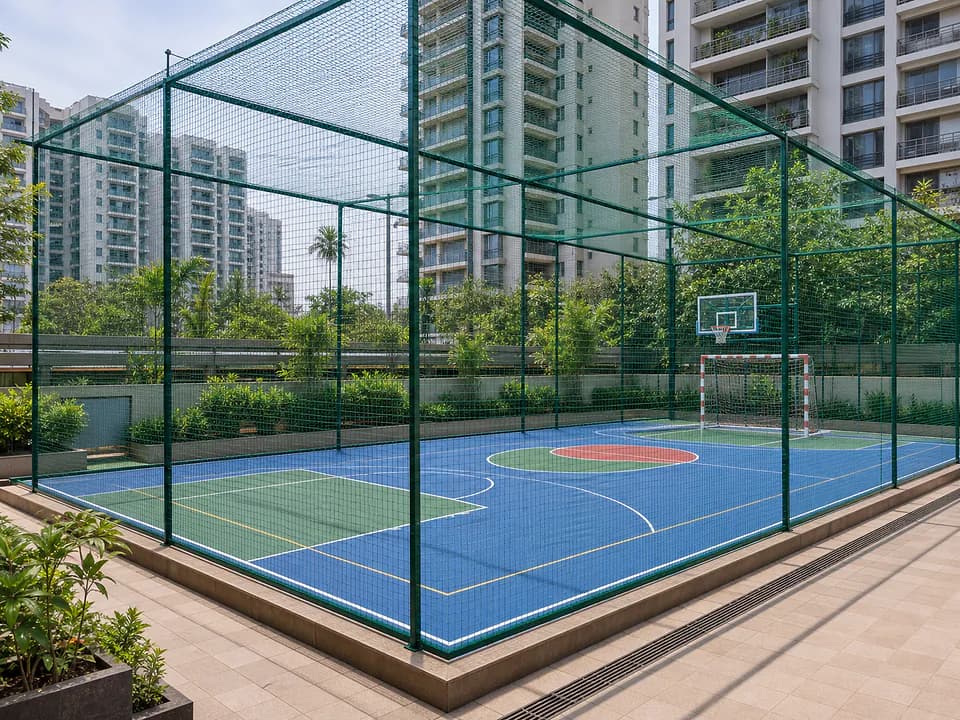Apartment sports court enclosed with ball-stop netting